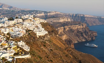 Cityscape of Fira town with white houses and the caldera in Santorini, Greece. Summer holidays,