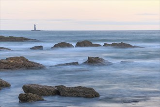 The lighthouse of the barges on the horizon seen from the beach of Sauveterre. Les Sables d'Olonne,