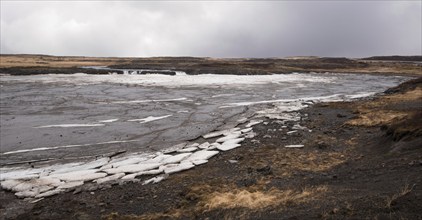 Typical Icelandic frozen lake with big ice cubes in the island of Iceland early in spring time