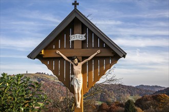 Wayside shrine, Christ on the cross, autumn atmosphere, forest with foliage colouring, near