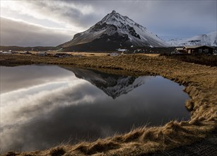 Mountain landscape at and hilltop reflection at a lake. Arnarstapi area in Snaefellsnes peninsula