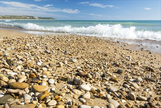 Beautiful rocky beach with turquoise ocean in the background