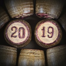 Wooden vintage lotto kegs with two numbers 20 and 19 as symbol of 2019 year. Close-up top view of