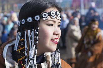 Portrait smiling young woman in traditional clothing indigenous inhabitants of Kamchatka.