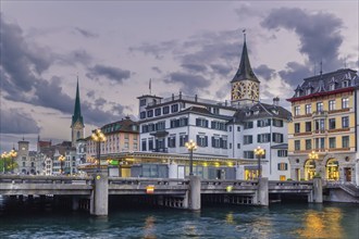 Embankment of Limmat river with view of St. Peter church in old town of Zurich, Switzerland, Europe