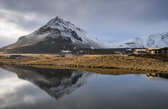 Mountain landscape at and hilltop reflection at a lake. Arnarstapi area in Snaefellsnes peninsula