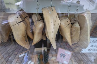 Shoe lasts on hooks in the window of a shoemaker's shop, Iphofen, Lower Franconia, Bavaria,