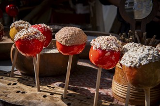 Yellow and red candied apples, medieval market, medieval week, former Hanseatic city of Visby,