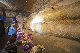 Pilgrims at the reclining Buddha in the Dambulla cave temple, Dambulla, Central Province, Sri