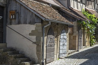 Former storage rooms, barns from the 15th century, in the historic fortified church, Hüttenheim,