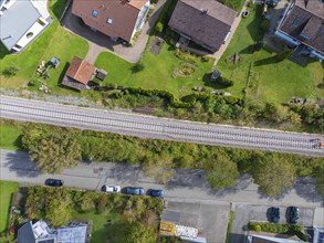 Aerial view of a railway line running through a residential area with neighbouring streets and