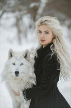 Beautiful young woman in winter coat with blond hair standing with her pet white wolf, AI generated