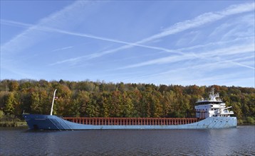 Cargo ship Nordborg sails through the Kiel Canal in autumn, Kiel Canal, Schleswig-Holstein,