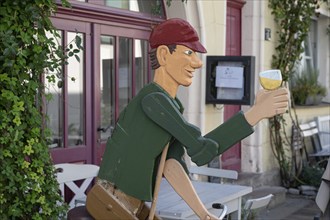 Wooden figure with wine glass in front of a pub, Iphofen, Lower Franconia, Bavaria, Germany, Europe