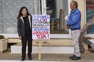 Two people at a protest, holding a sign with demands in Greek, Visit of Federal President