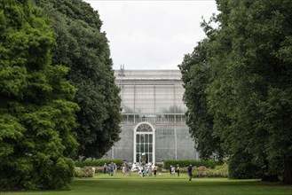 Visitors in front of the Palm House, the oldest Victorian greenhouse in the world, Royal Botanic