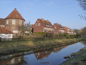 Picturesque village with brick houses along a small river with a wonderful reflection, coesfeld,