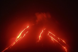 Volcanic landscape of Kamchatka Peninsula: night view of eruption Klyuchevskoy Volcano, current red