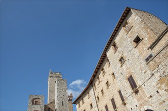 Medieval historical architecture buildings, San Gimignano city Tuscany, Italy against blue sky