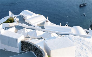 Santorini traditional charming white architecture, and blue sea Cyclades Greek islands, Greece,