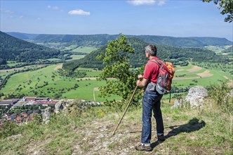 Male hiker taking a break and enjoying the beautiful landscape