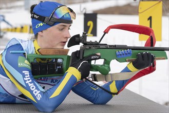 Biathlete Kryukova Arina Republic of Kazakhstan rifle shooting in prone position. Biathlete in