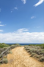 Foot path towards the ocean with red sand on the island of Sicily, Italy, Europe