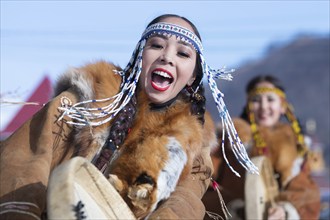 Female dancing with tambourine in national clothing indigenous inhabitants Kamchatka. Concert,