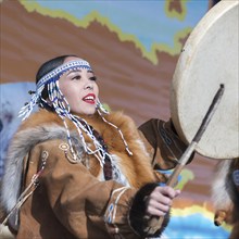 Woman in national clothing indigenous inhabitants Kamchatka dancing with tambourine. Concert,