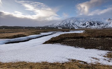 Typical Icelandic landscape with mountains and meadow land covered in snow at snaefellsnes