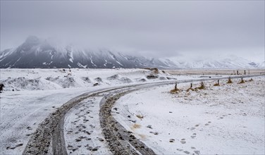 Empty highway countryside frozen road with snow in winter in Iceland