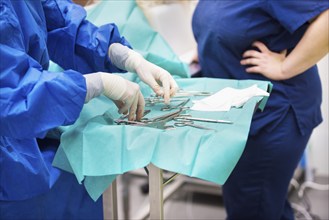 Nurse preparing medical instruments for operation