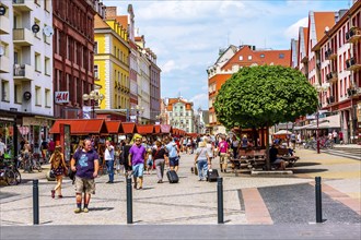 Wroclaw, Poland, June 21, 2019: Stalls with traditional goods near Market Square, colorful houses