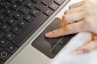 Female hand using track pad on a laptop