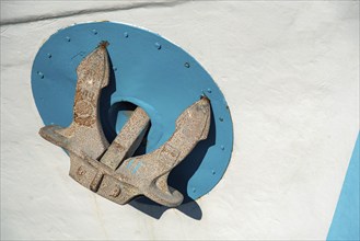 Rusty Anchor on white boat