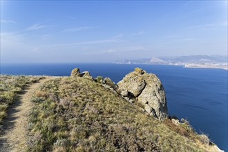 Footpath on a steep coastal mountain. Cape Meganom, Crimea, sunny day in September