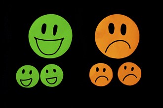 Set of smile and sadness emoticons isolated on black background. Line icons emoticons. Happy and