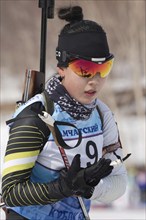 Korean sportswoman biathlete Lee Hyunju South Korea skiing in stadium of biathlon complex during