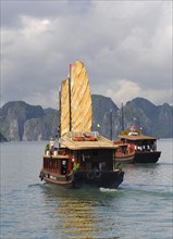 Halong Bay, Vietnam, August 5 2010: Tourist boat sailing on the famous Halong bay transferring