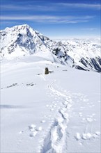 Track in the deep snow on a mountain summit in winter