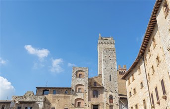 Medieval historical architecture buildings, San Gimignano city Tuscany, Italy against blue sky