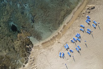 Drone aerial of beach umbrellas in the beach. Summer holidays in the sea. Paphos Cyprus Europe