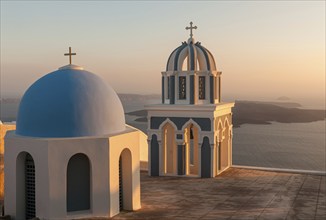 Church domes of a christian orthodox church during sunset at the greek island of Santorini in the