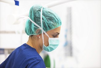 Portrait of nurse with mask in surgery room