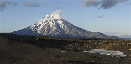 Panorama: beautiful mountain landscape at sunset, view of cone of Bolshaya Udina Volcano. Russia,