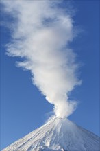 Winter volcanic landscape: active Klyuchevskaya Sopka (Klyuchevskoy Volcano), view of the top of