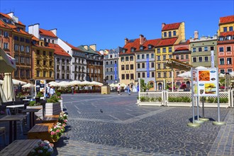 Warsaw, Poland, June 24, 2019: Mermaid of Warsaw, Syrenka Warszawska, colorful houses in Market