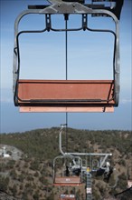 Empty ski lift for transporting skiers at snow slope for skiing in winter