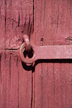 Wood background of red wooden door. Iron metal safety locker. Wood textures