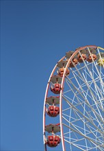 Ferris wheel isolated on blue sky background, Having fun on an amusement fairground park